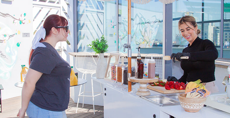 Two women chatting beside a product display