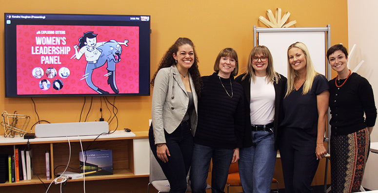 Group photo beside a screen showing a leaderboard