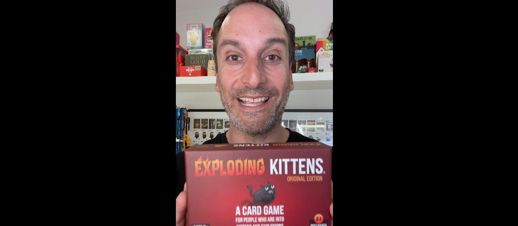 Man holding a game in a video thumbnail 
